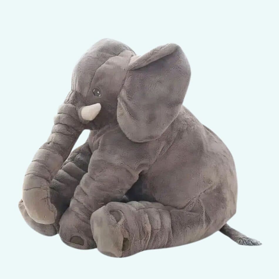 Stuffed animals subcategory: Cozy elephant plushies, soft toys, kids' room decor. Home setting, cuddly, baby shower gift, gray elephant.